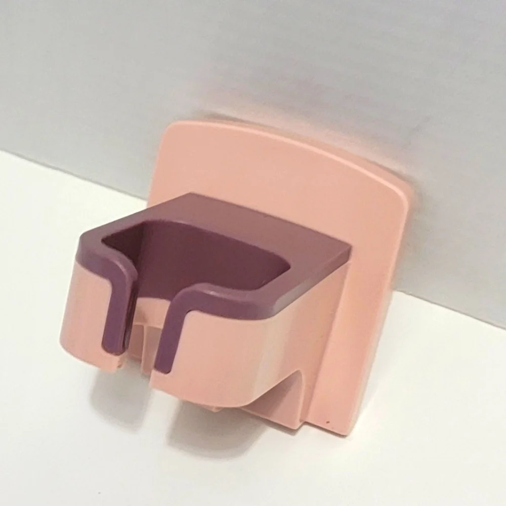 Pink and Purple Wall-Mounted Blow Dryer Holder.
